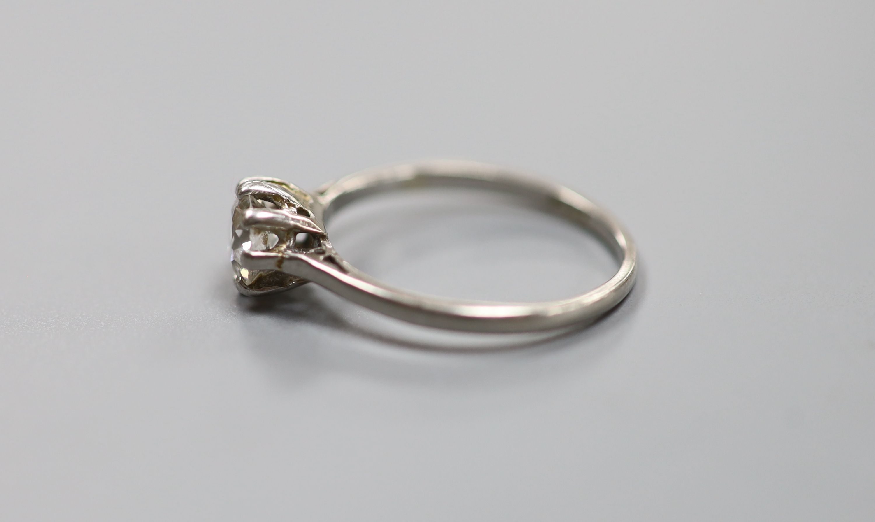 A white metal (stamped plat) and solitaire diamond ring